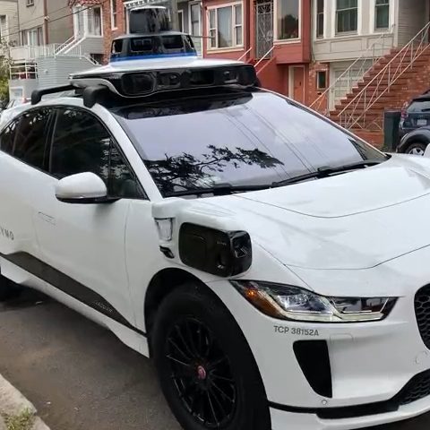 A Waymo self-driving car parked on a street in San Francisco on April 29, 2023. After several minutes in a parking space, the car backed up, pulled out into the street and drove off. There was no one in the car during the entire process.