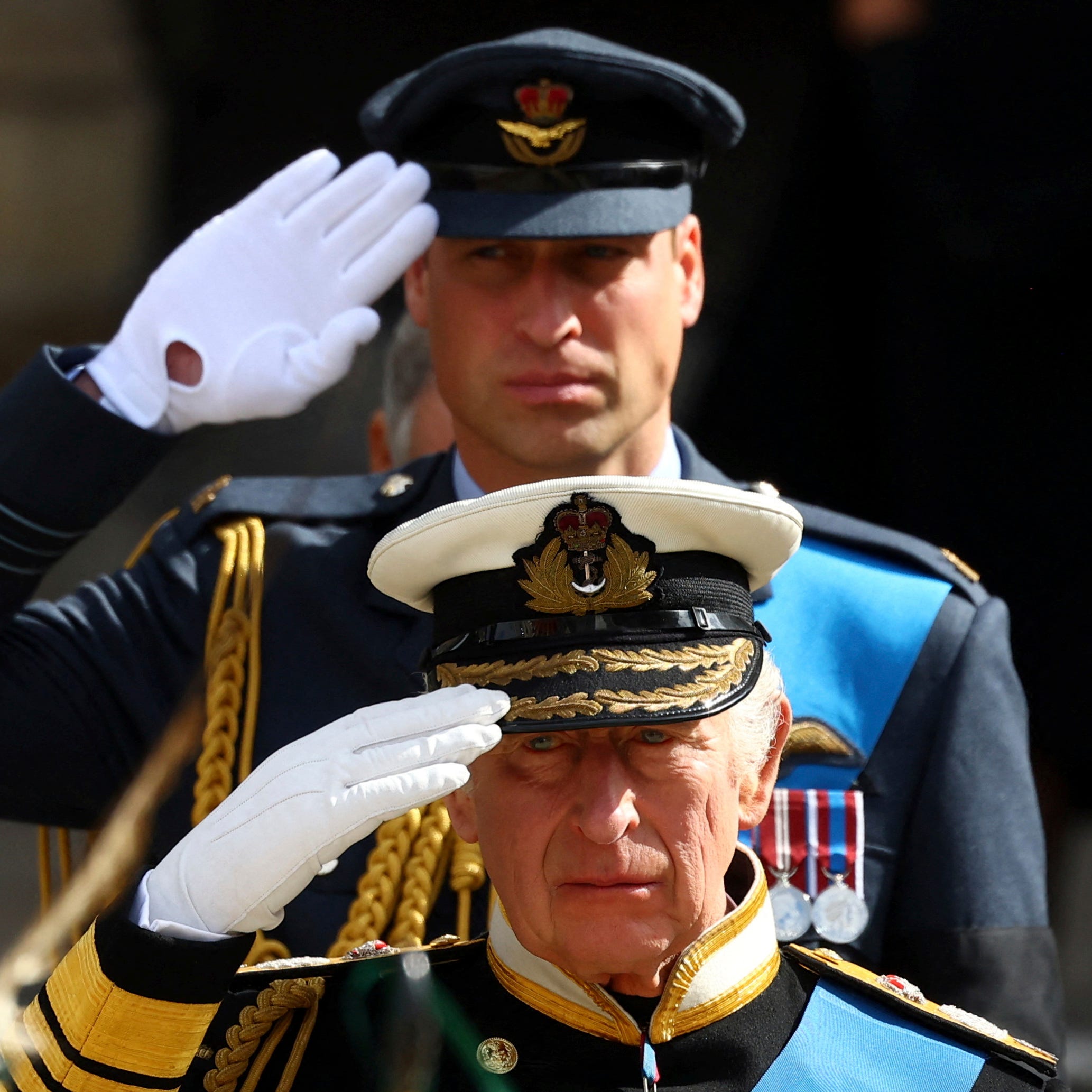 Britain's King Charles III and Prince William salute as they attend the state funeral and burial of Britain's Queen Elizabeth, in London, Monday Sept. 19, 2022. (Hannah Mckay/Pool Photo via AP) ORG XMIT: LFP454