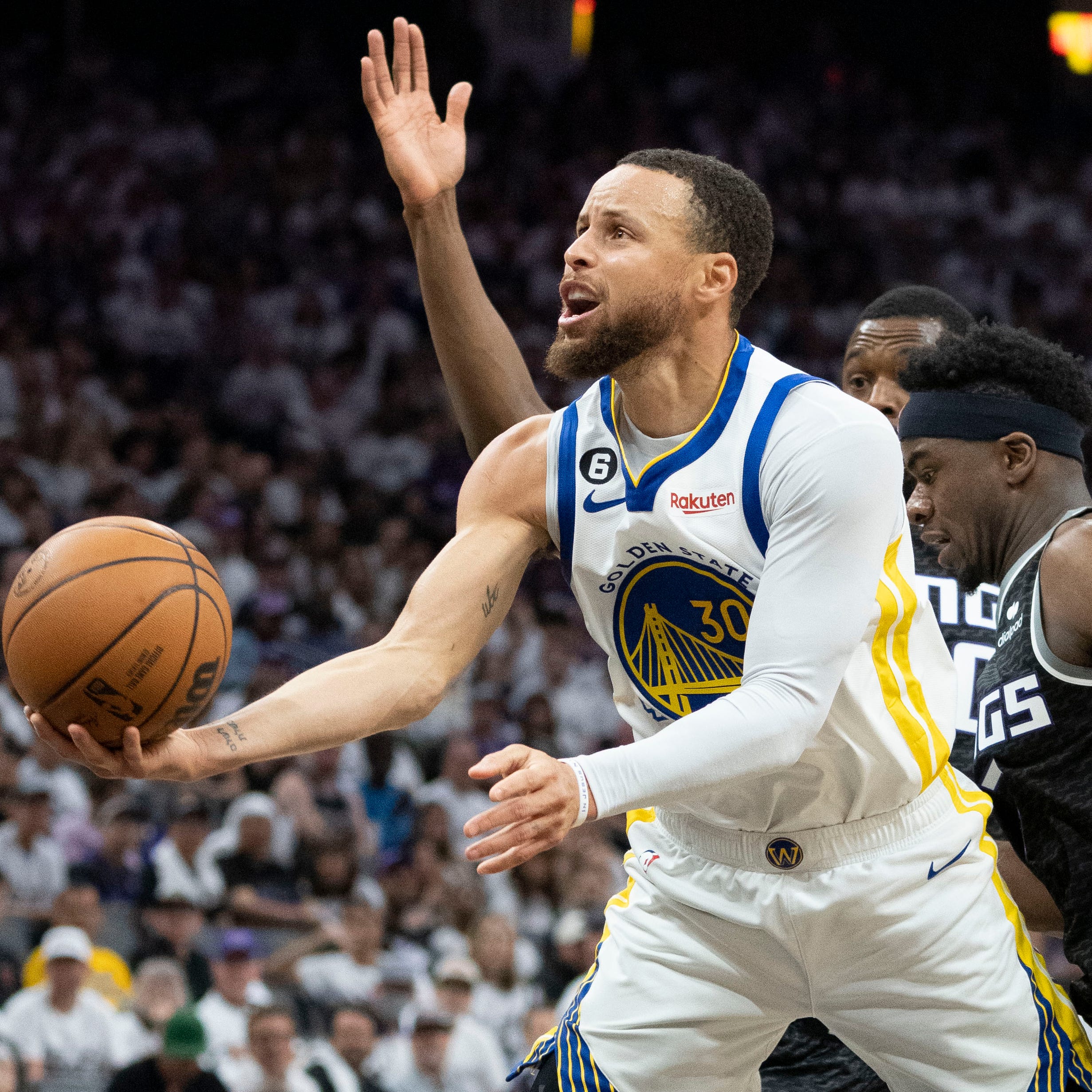 Golden State Warriors guard Stephen Curry drives past Sacramento Kings forward Harrison Barnes (40) and guard Terence Davis (3) during Game 7 of their first-round series.