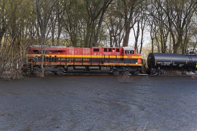 A train travels along tracks surrounded by floodwater from the Mississippi River on May 1, 2023, near Bellevue, Iowa. Although the Mississippi River crested in the area on Saturday, according to the National Weather Service, the River at Bellevue is not expected to drop below the major flood stage until next weekend.