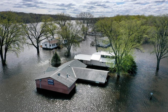 In this aerial view, homes are surrounded by floodwater on May 1, 2023, in East Dubuque, Illinois. Although the Mississippi River crested in the area on Saturday, according to the National Weather Service, the river is not expected to drop below major flood stage until May 5.