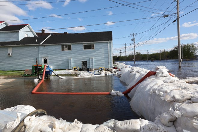 A sandbag levee protects the business district from Mississippi River floodwater on May 1, 2023, in Savanna, Illinois. According to the National Weather Service, the river is expected to crest in the area today and is expected to remain at a major flood stage through the weekend.