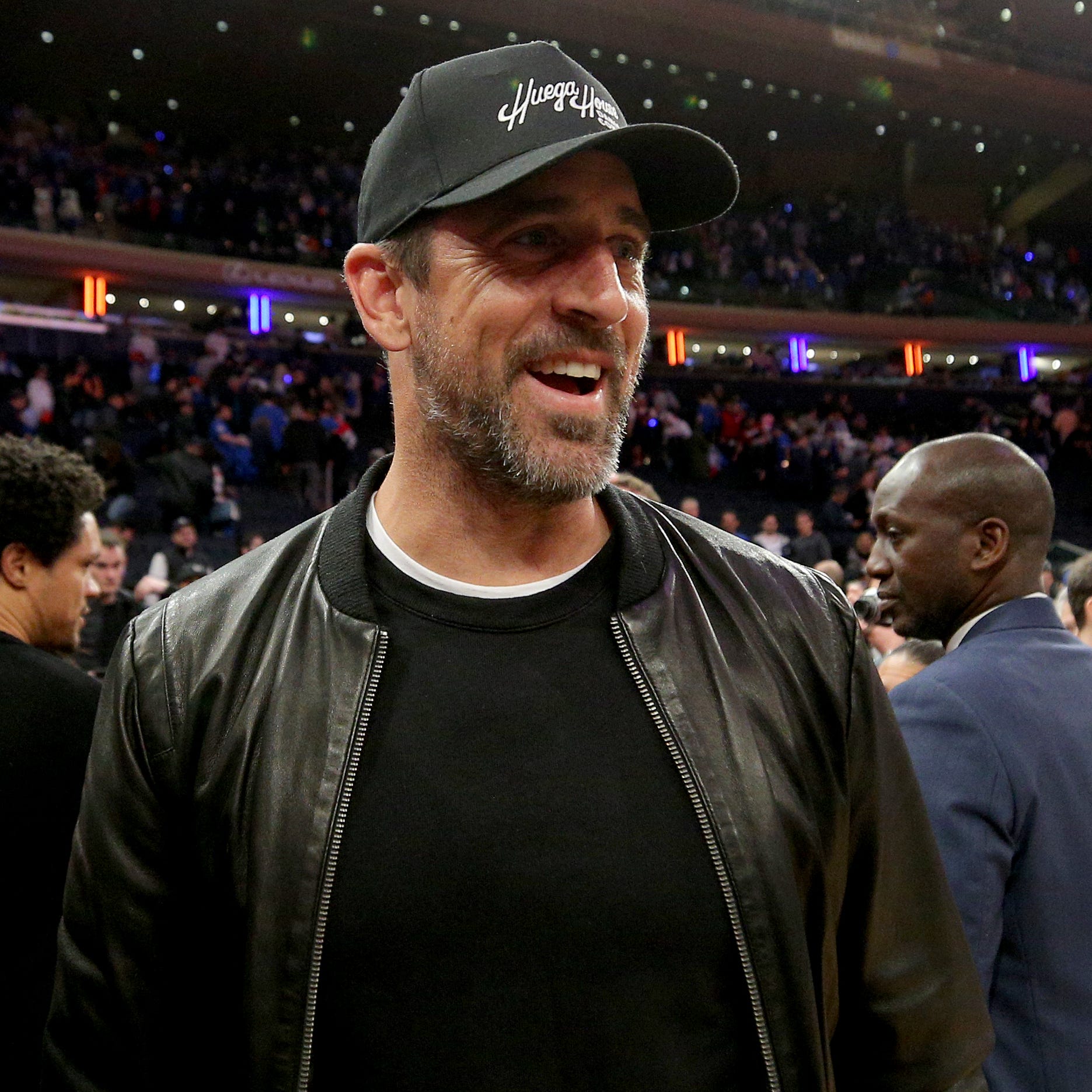 New York Jets quarterback Aaron Rodgers walks off the court after game one of the 2023 NBA Eastern Conference semifinal playoffs between the New York Knicks and the Miami Heat at Madison Square Garden.