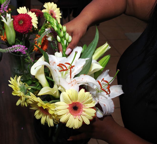 Starting with a basic arrangement of large flowers for a continuous flow, Forall designer Keanna Banks of Brockton gradually adds more to amp up the design, depending on whether she wants a symmetrical design or an asymmetrical design.  Tuesday, May 2, 2023.
