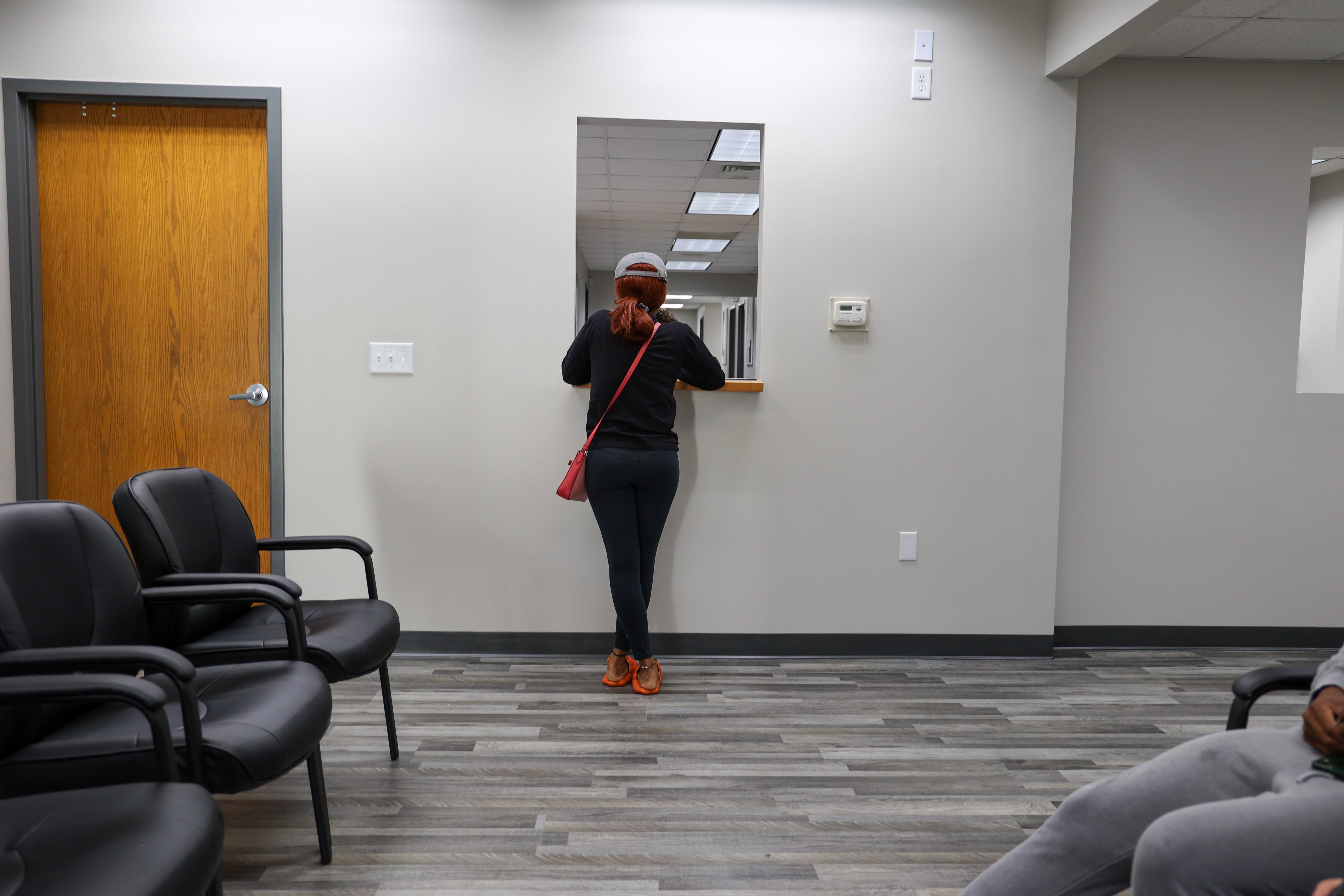 A woman stands at the window of the Alamo Women’s Clinic in Carbondale, Illinois, November 3, 2022.