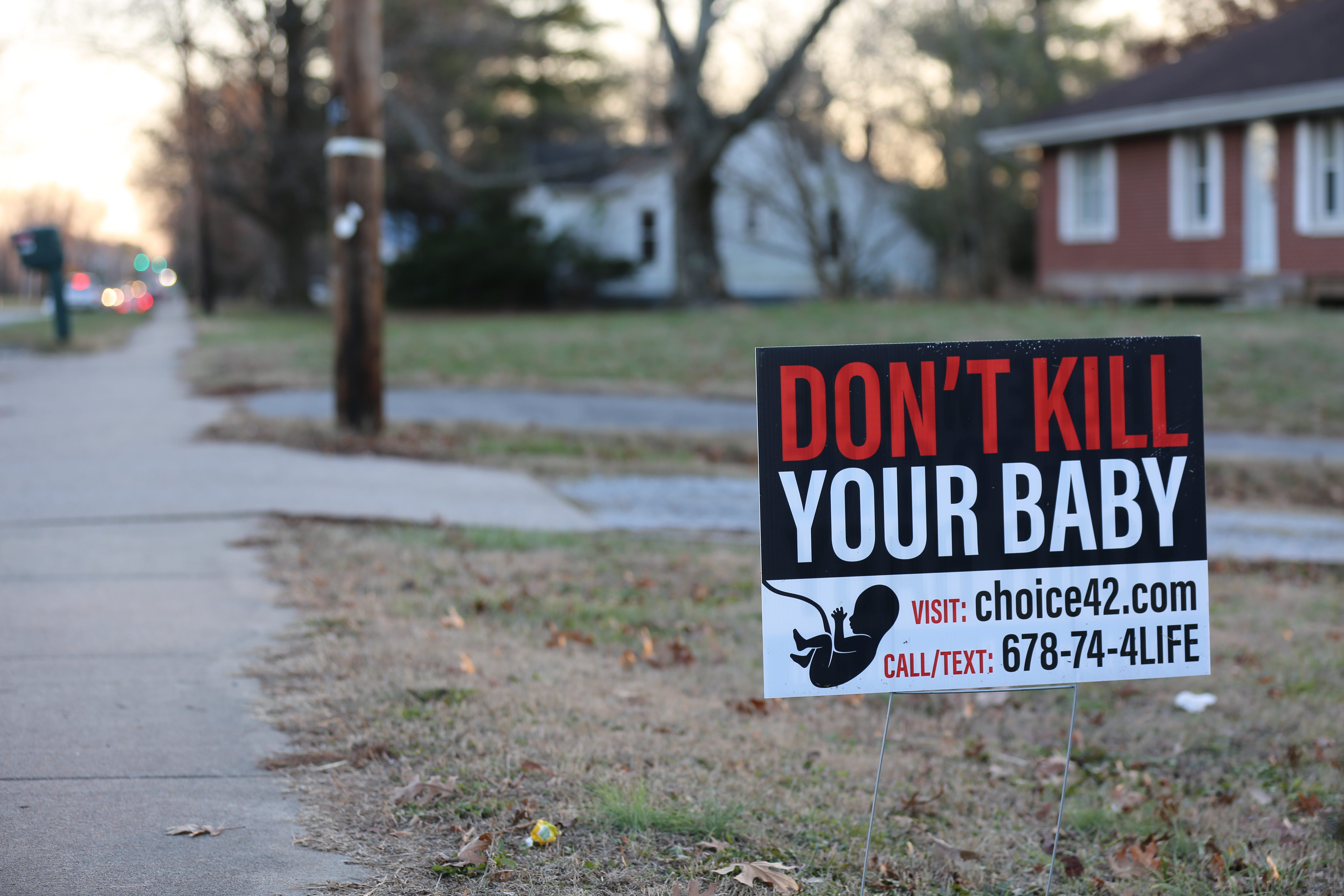 A lawn sign in December 2022. In Carbondale, not everyone was ready to welcome the clinics – or the city's new reputation.