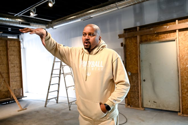 Owner Desmond Ferguson talks about the progress inside Moneyball Sportswear's new headquarters on Tuesday, May 2, 2023, in Lansing.