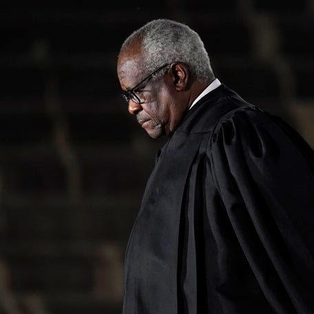 Supreme Court Justice Clarence Thomas listens as President Donald Trump speaks before administering the Constitutional Oath to Amy Coney Barrett on the South Lawn of the White House in Washington, Monday, Oct. 26, 2020, after she was confirmed by the Senate earlier in the evening. (AP Photo/Patrick Semansky)