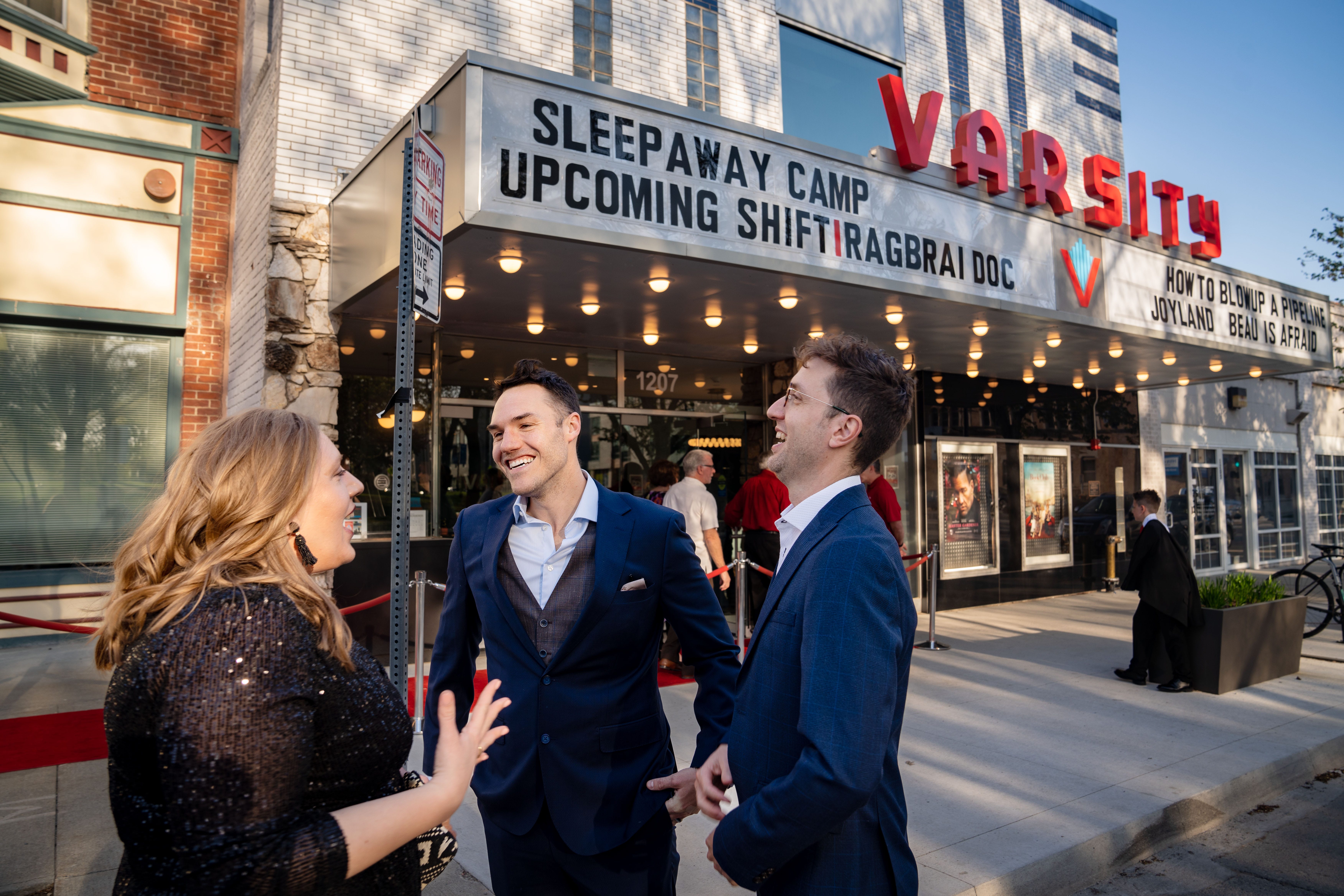 Co-Director Kelsey Kremer talks with cast members Ian Zahren and Andrew Boddicker before the premiere of "SHIFT: The RAGBRAI Documentary" before a sold-out crowd at Varsity Cinema, Thursday, May 4, 2023.