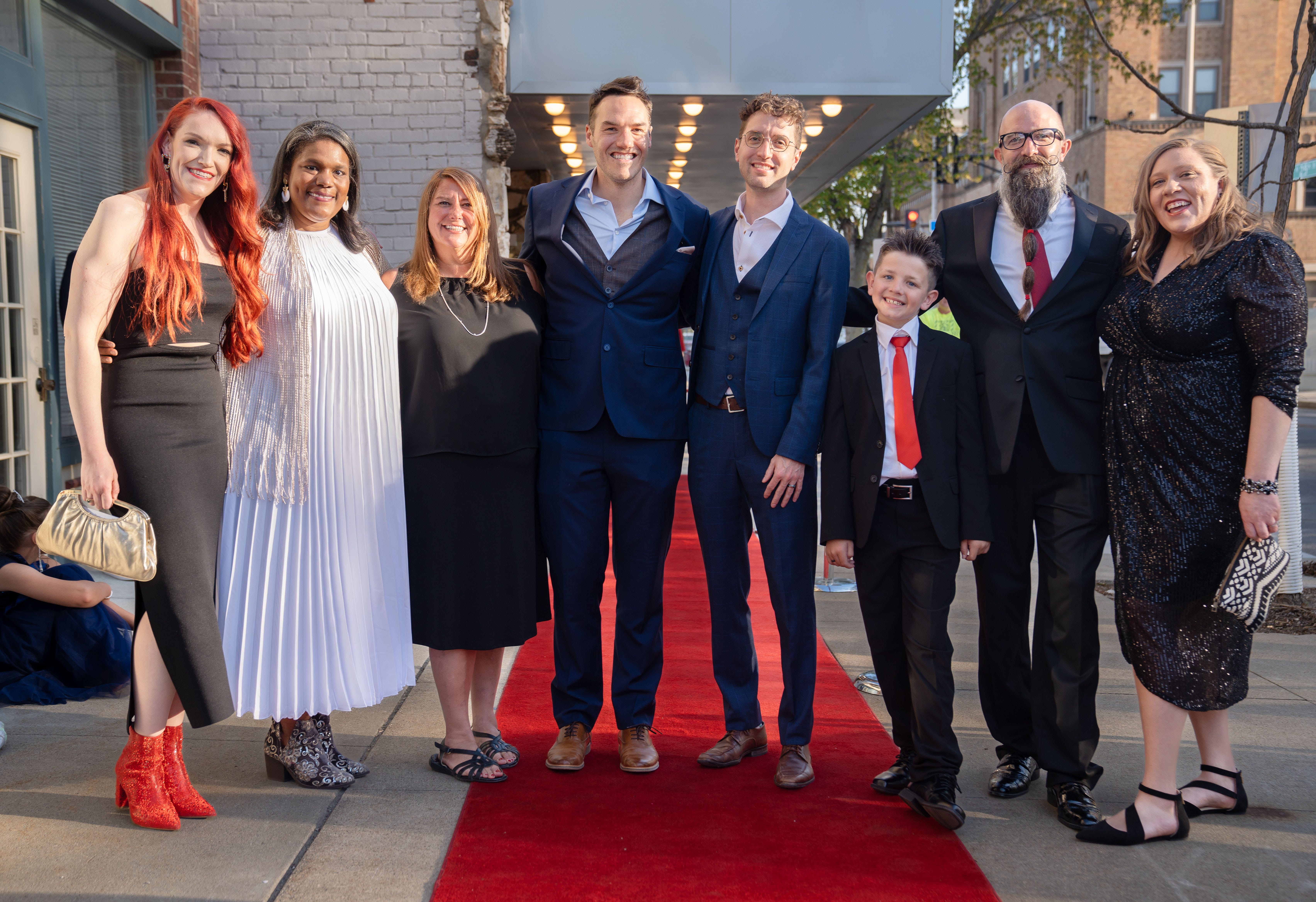 Film Directors and cast from left, Courtney Crowder, Dayna Chandler, Torie Giffin, Ian Zahren, Andrew Boddicker, Liam Lineberry, Adam Lineberry, and Kelsey Kremer stand for a photo outside the Varsity Cinema before the premiere of 'Shift: The RAGBRAI Documentary' Thursday, May 4, 2023. 