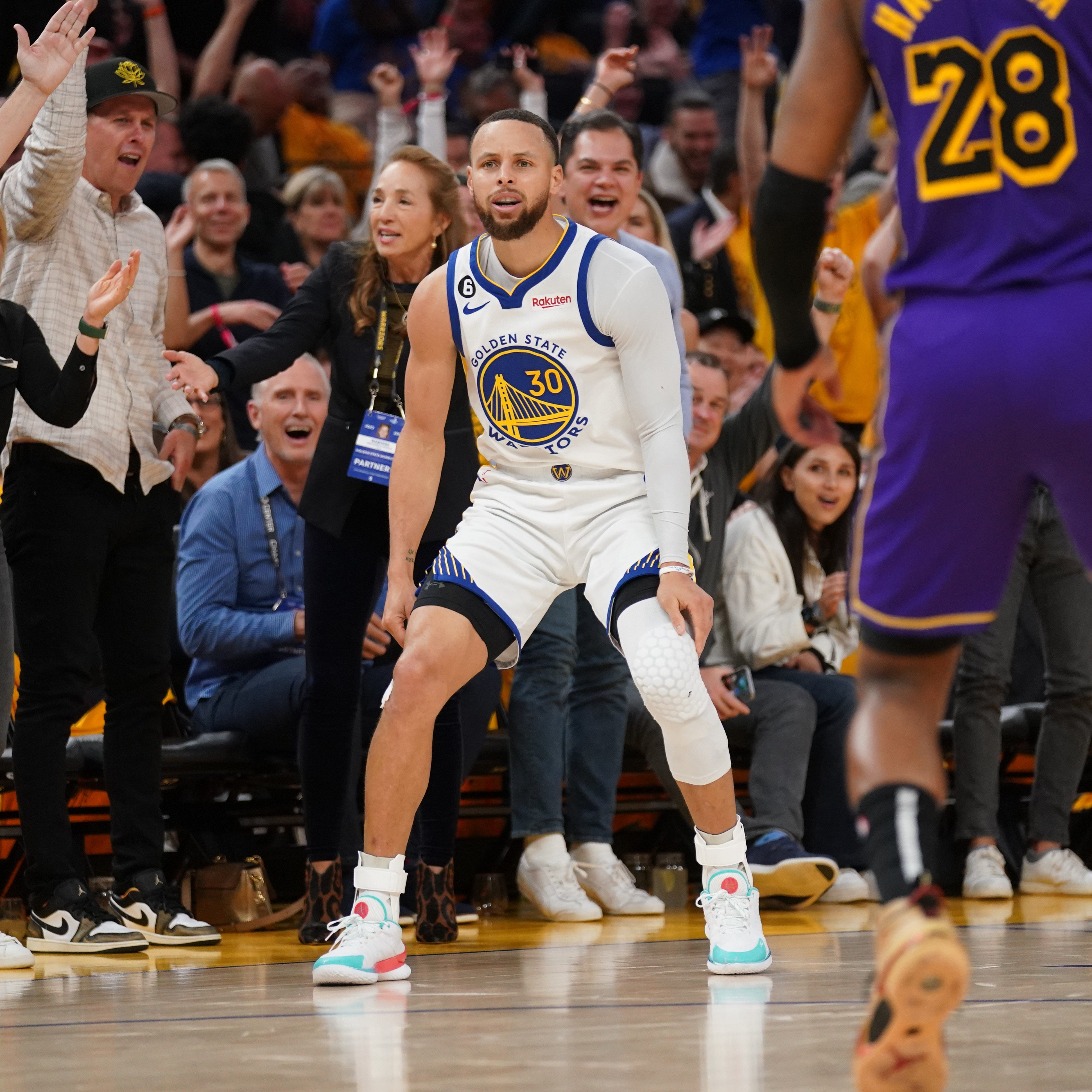 Golden State Warriors guard Stephen Curry (30) reacts after making a 3-point basket against the Los Angeles Lakers in the third quarter of Game 2  of their playoff series.
