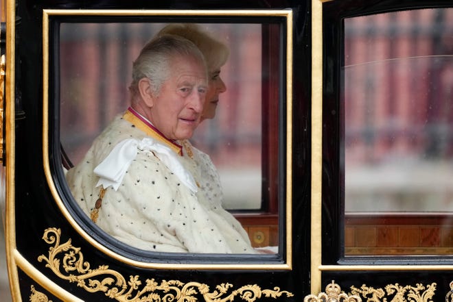 King Charles III and Camilla, Queen Consort traveling in the Diamond Jubilee Coach, built in 2012 to commemorate the 60th anniversary of the reign of Queen Elizabeth II, at Buckingham Palace ahead of the coronation on May 6, 2023, in London.