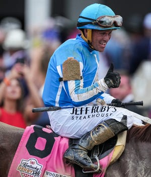 After winning the 149th Kentucky Derby, jockey Javier Castellano celebrates aboard Mage as they are lead to the Winner's Circle by outrider Greg Blasi Saturday at Churchill Downs in Louisville, Ky. May, 6, 2023.