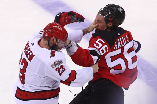 Carolina Hurricanes right wing Stefan Noesen, left, and New Jersey Devils left wing Erik Haula fight during the third period in Game 3 of the second round of the 2023 Stanley Cup Playoffs on May 7.