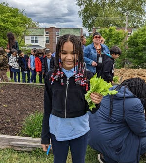 Healthy Foods for Healthy Kids and William C. Lewis Dual Language Elementary School celebrate the students’ first spring harvest at the Rodney Reservoir Community Garden in Wilmington, Delaware, on May 4, 2023. The partnership has created an "outdoor classroom" experience for students of the magnet elementary school.