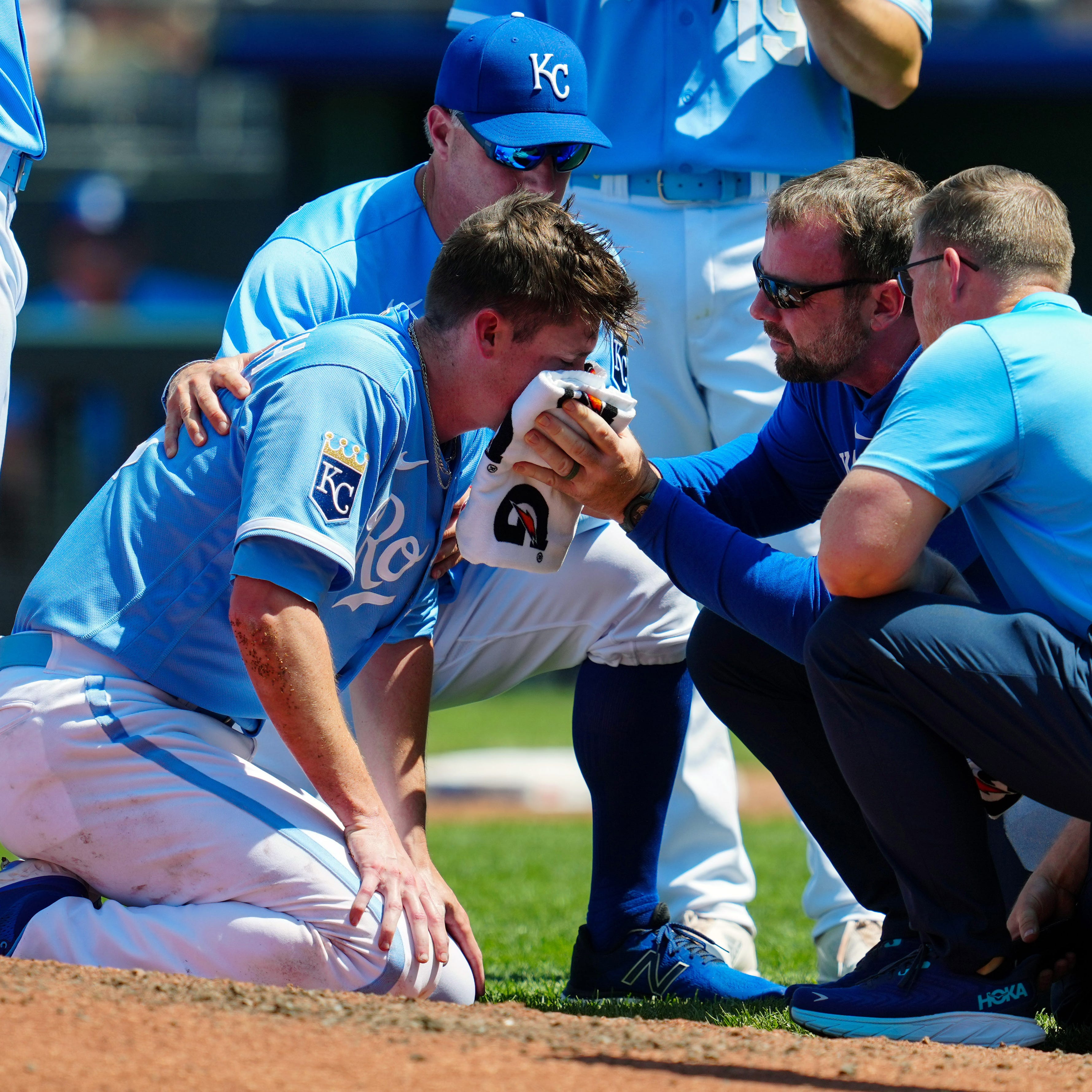 Kansas City Royals pitcher Ryan Yarbrough is attended to by medical staff after being hit by a line drive off the bat of the Oakland Athletics' Ryan Noda.