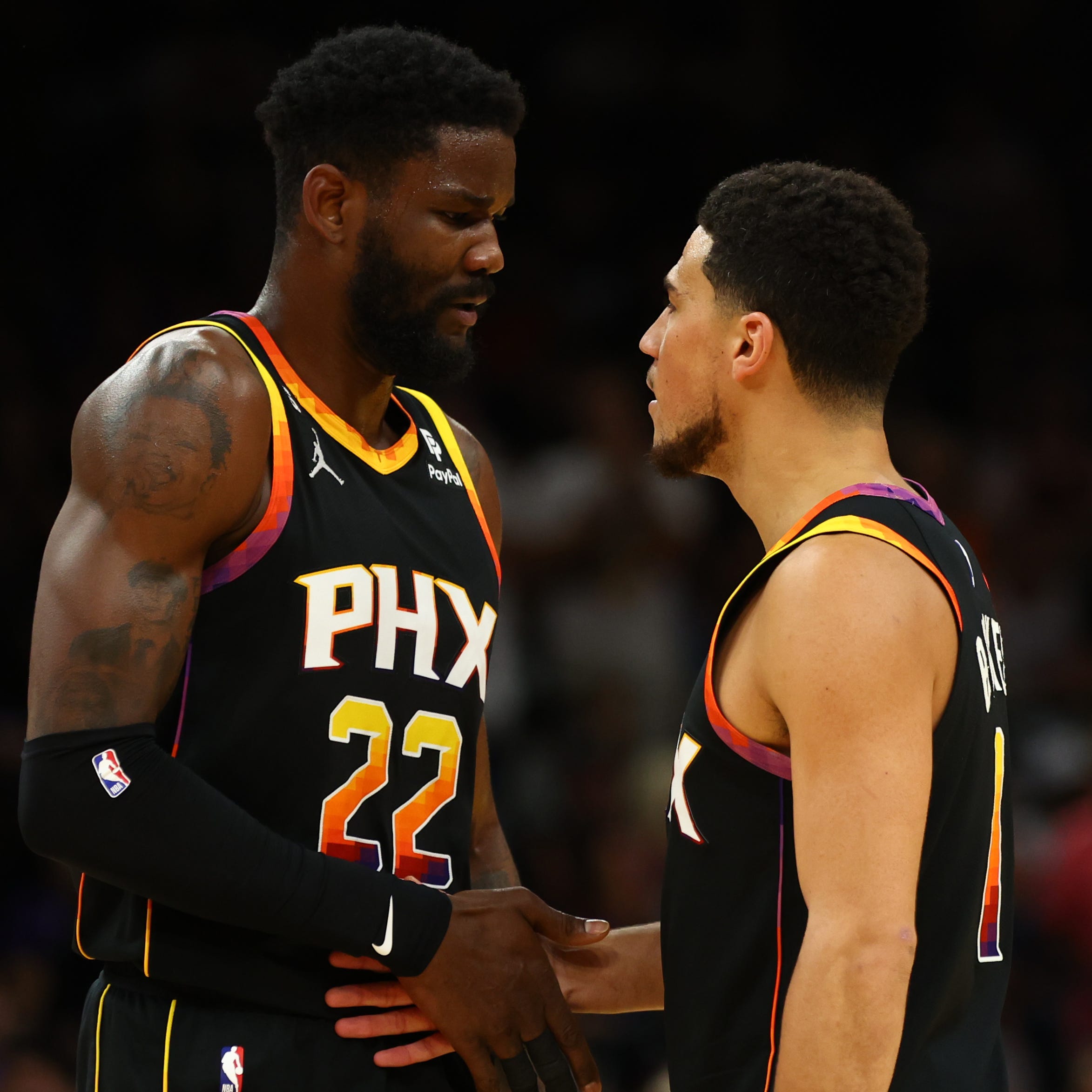 Deandre Ayton (22) and Devin Booker react during the Phoenix Suns' Game 4 win over the Denver Nuggets.
