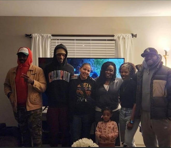 Jasmine Bennett, center, poses with her family during a game night.
