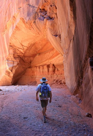 Roger Naylor hikes through Buckskin Gulch slot canyon in northern Arizona.