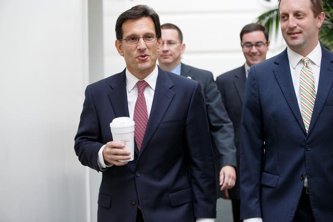 House Majority Leader Eric Cantor of Va., left, arrives for a House Republican strategy session on Capitol Hill in Washington, Tuesday, July 29, 2014.