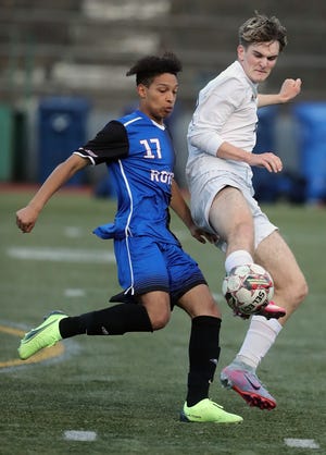 Bainbridge's Hudson Reynolds and Kent Meridian's Andres Zaluaga (17) battle for control of the ball during their District 3/4 3A Boys Soccer match at the Stadium Bowl in Tacoma on Thursday, May 11, 2023. Kent Meridian won the game 1-0.