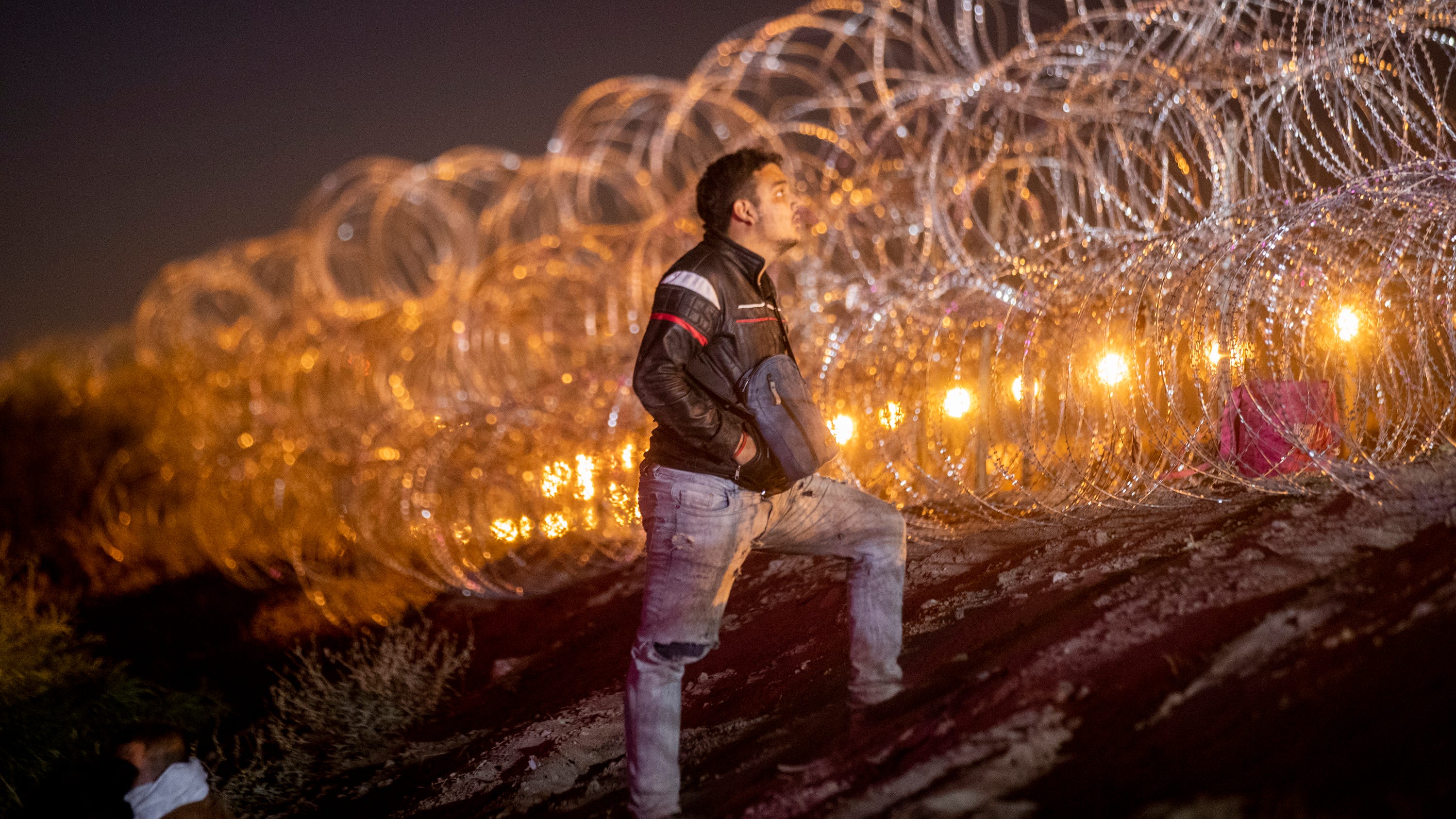 A migrant pleads with a Texas National Guard to let his family pass the concertina wire on the embankment of the Rio Grande to join hundreds of other migrants who surrendered to Customs and Border Protection 40 minutes before Title 42 was set to expire. The migrants were refused further access to U.S. territory.