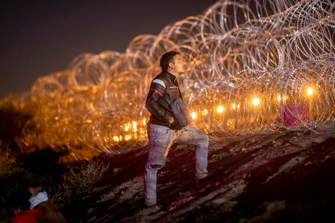 A migrant pleads with a Texas National Guard to let his family pass the concertina wire on the embankment of the Rio Grande to join hundreds of other migrants who surrendered to Customs and Border Protection 40 minutes before Title 42 was set to expire. The migrants were refused further access to U.S. territory.
