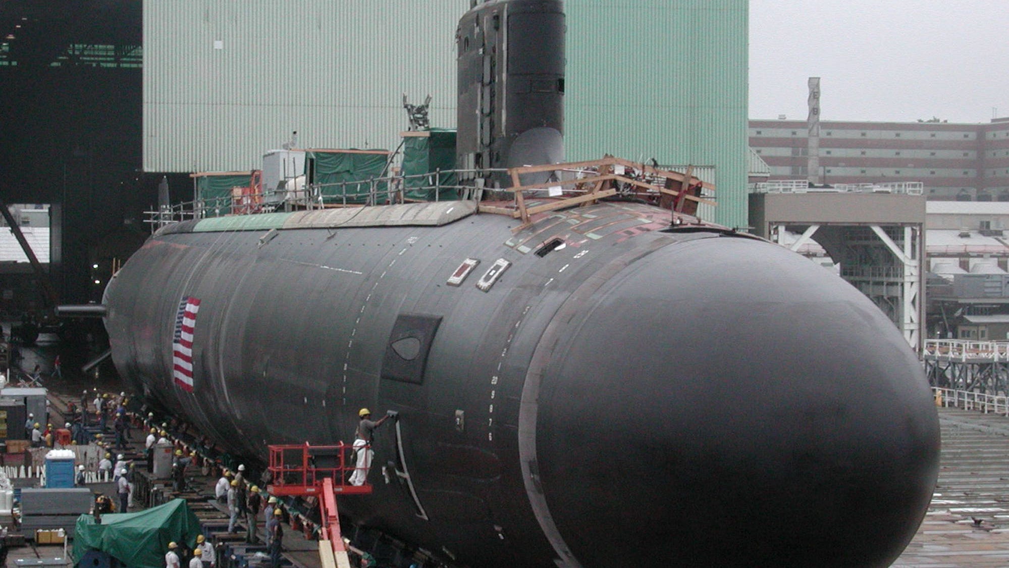 The Navy's newest and most advanced nuclear attack submarine, Virginia (SSN-774), is moved outdoors for the first time Saturday, Aug. 2, 2003, at the General Dynamics Electric Boat shipyard in Groton, Conn. The Virginia will be christened at a shipyard ceremony Saturday, Aug. 16. (AP Photo/Carol Phelps) ORG XMIT: CTCP102