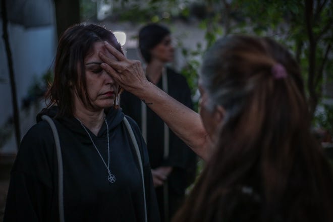 Jussara Gabriel a Wiccan High priestess blesses the first-degree priestesses during the  the Imbolc, the seasonal sabbat in honor of Brigid, a Celtic goddess of Irish origin, on August 13, 2020 in Jacarepagua, Rio de Janeiro, Brazil. Because of the pandemic, coven members have taken precautions but do not wear protective masks during rituals. The expression "Perfect love and perfect trust" is used to demonstrate the bonds of unity and trust between them in the face of the risk of contamination.