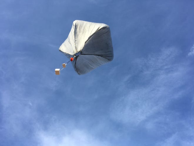 A Sandia National Laboratories solar-powered hot air balloon taking flight bears sensors including a GPS tracker and reusable infrasound sensor.