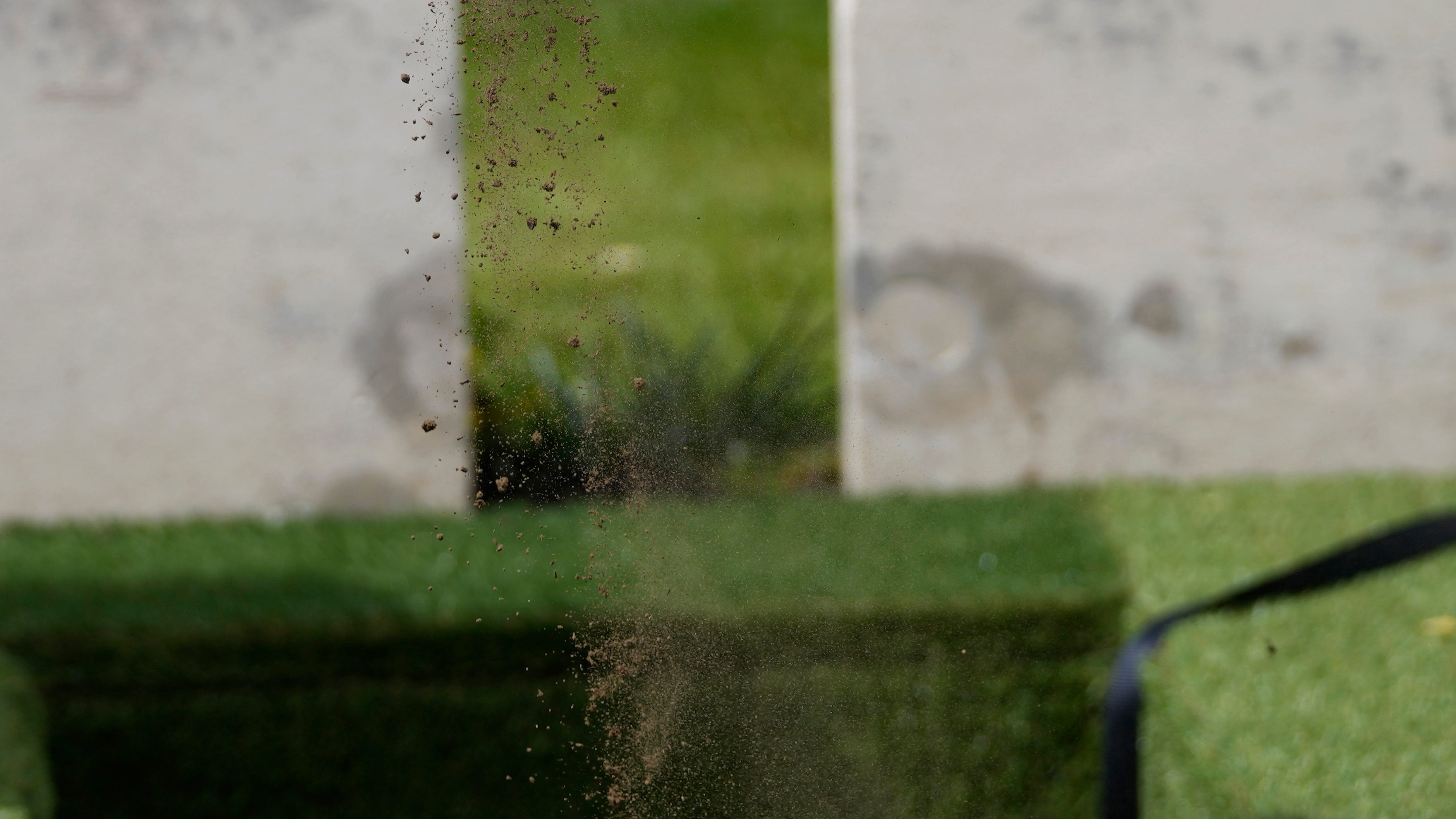 A relative of World War I soldier Private Robert Kenneth Malcolm sprinkles earth on the grave during a burial ceremony at the Commonwealth War Graves Commission's Bedford House Cemetery in Ypres, Belgium, Wednesday, May 10, 2023. Private Malcolm, from Stockton-on-Tees, County Durham, United Kingdom, was a stretcher bearer and went missing at the age of 23 in 1917. His remains were recovered in 2019.