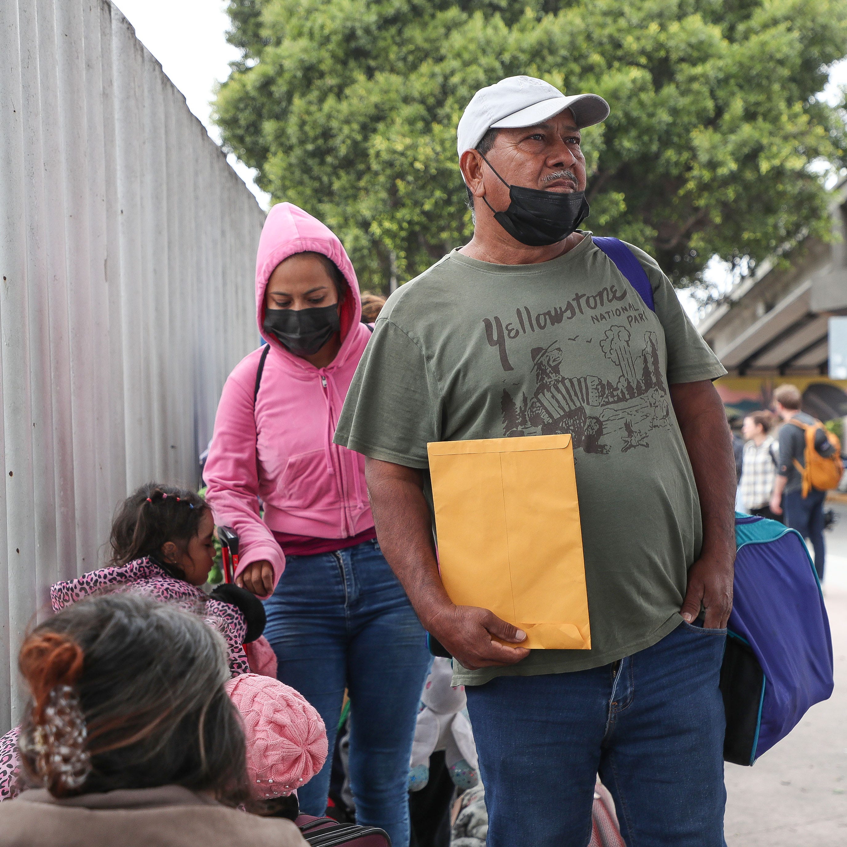 Amador Diaz, right, from Guerreo, Mexico waits with his family to be processed at the El Chapparel Port of Entry in Tijuana, Mexico, May 12, 2023.