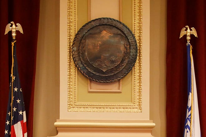 The seal of the City of Minneapolis is displayed during a city council meeting.