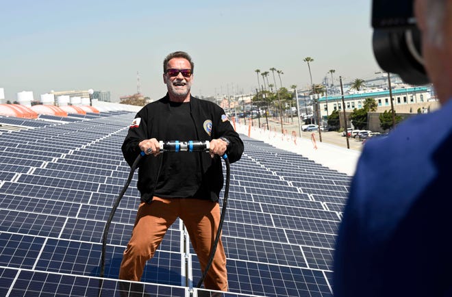 Former California Gov. Arnold Schwarzenegger poses for photos as he energizes the 4-acre solar rooftop of the AltaSea warehouse at the Port of Los Angeles in San Pedro, Calif., Friday, April 21, 2023.