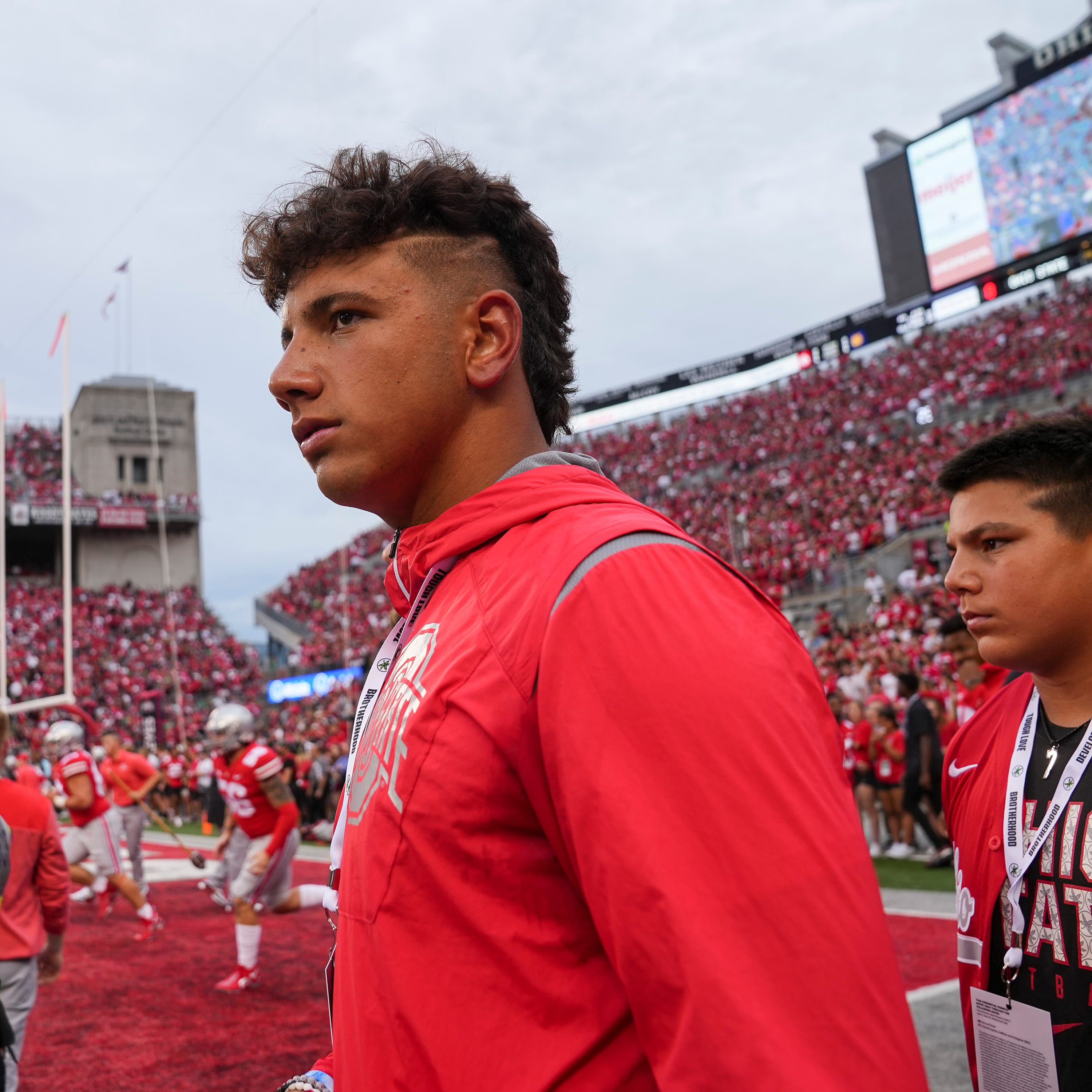 Quarterback recruit Dylan Raiola walks the sideline during the Ohio State Buckeyes and Notre Dame Fighting Irish game.