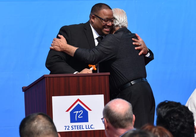 Aliquippa Mayor Dwan Walker hugs developer Chuck Betters at a 72 Steel groundbreaking ceremony.