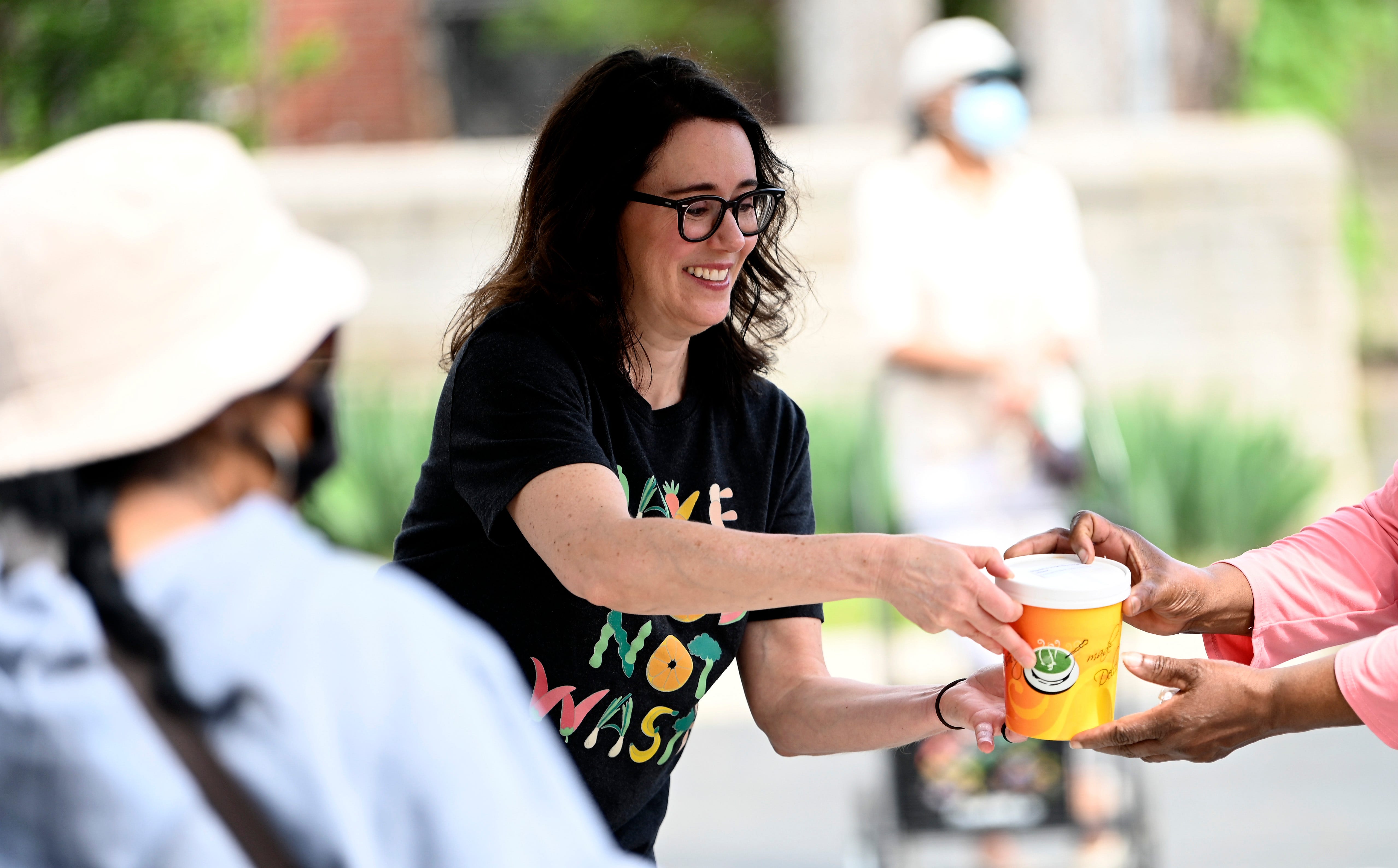 Make Food Not Waste Executive Director Danielle Todd offers soup to members of the community during food distribution in the Jefferson Avenue Presbyterian Church parking lot in Detroit.