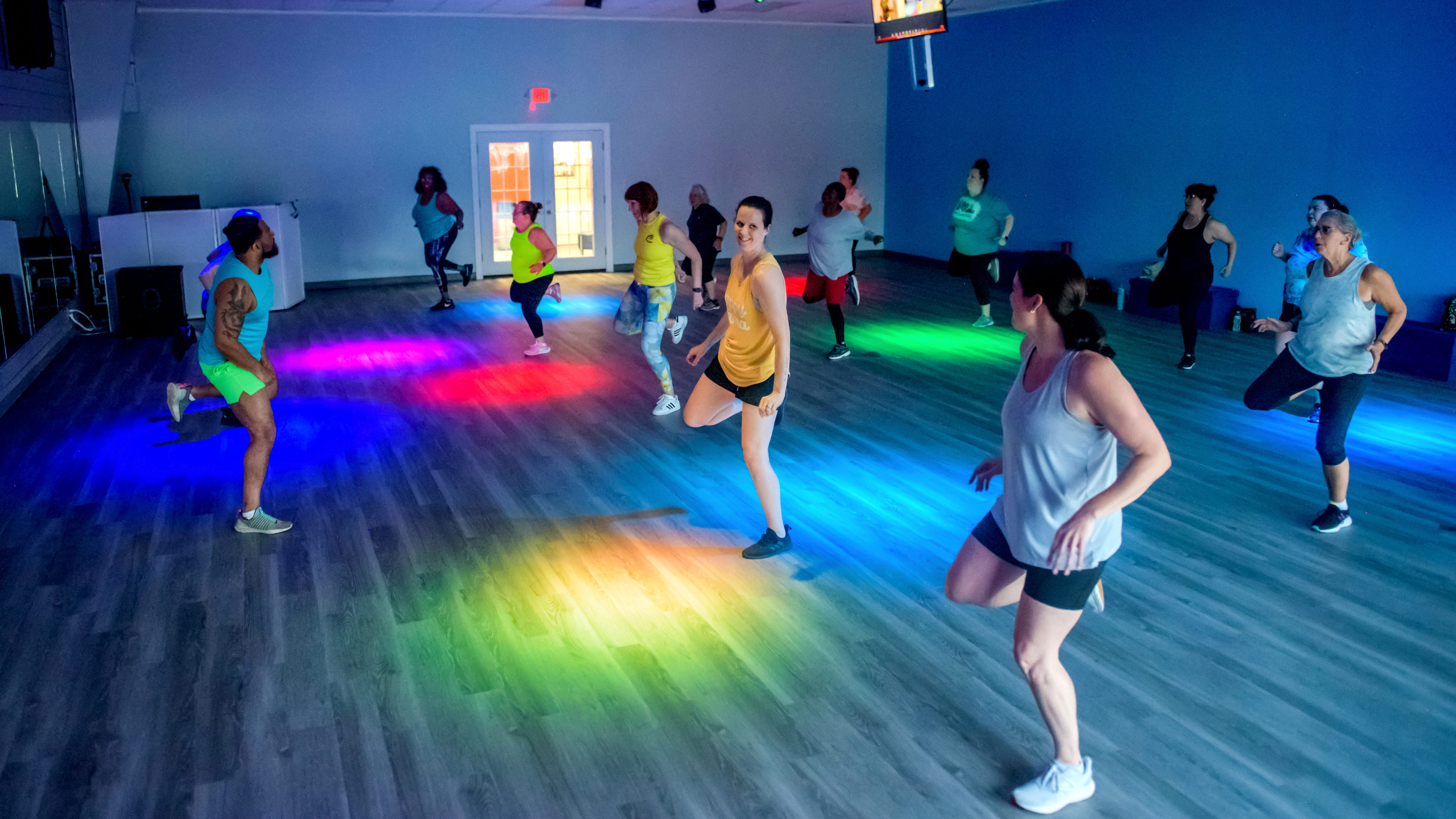 Members of Studio C Fitness work out in a Zumba class led by instructor AJ Jordan-Haywood, far left in green shorts, and co-owner J'r Haywood at the business's new location at 3611 W. Willow Knolls Drive in Peoria. Haywood and co-owner Kathy Plouzek moved from their location in Keller Station at the end of April into a space next to the Training Domain personal training facility and also into a second location at Northwoods Mall.