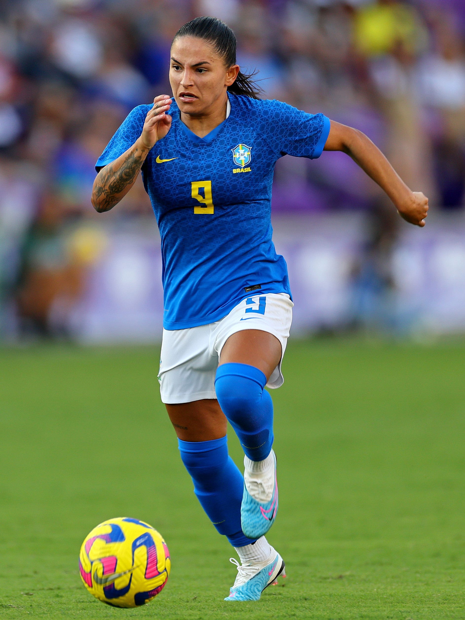 An action image of Debinha playing soccer.
