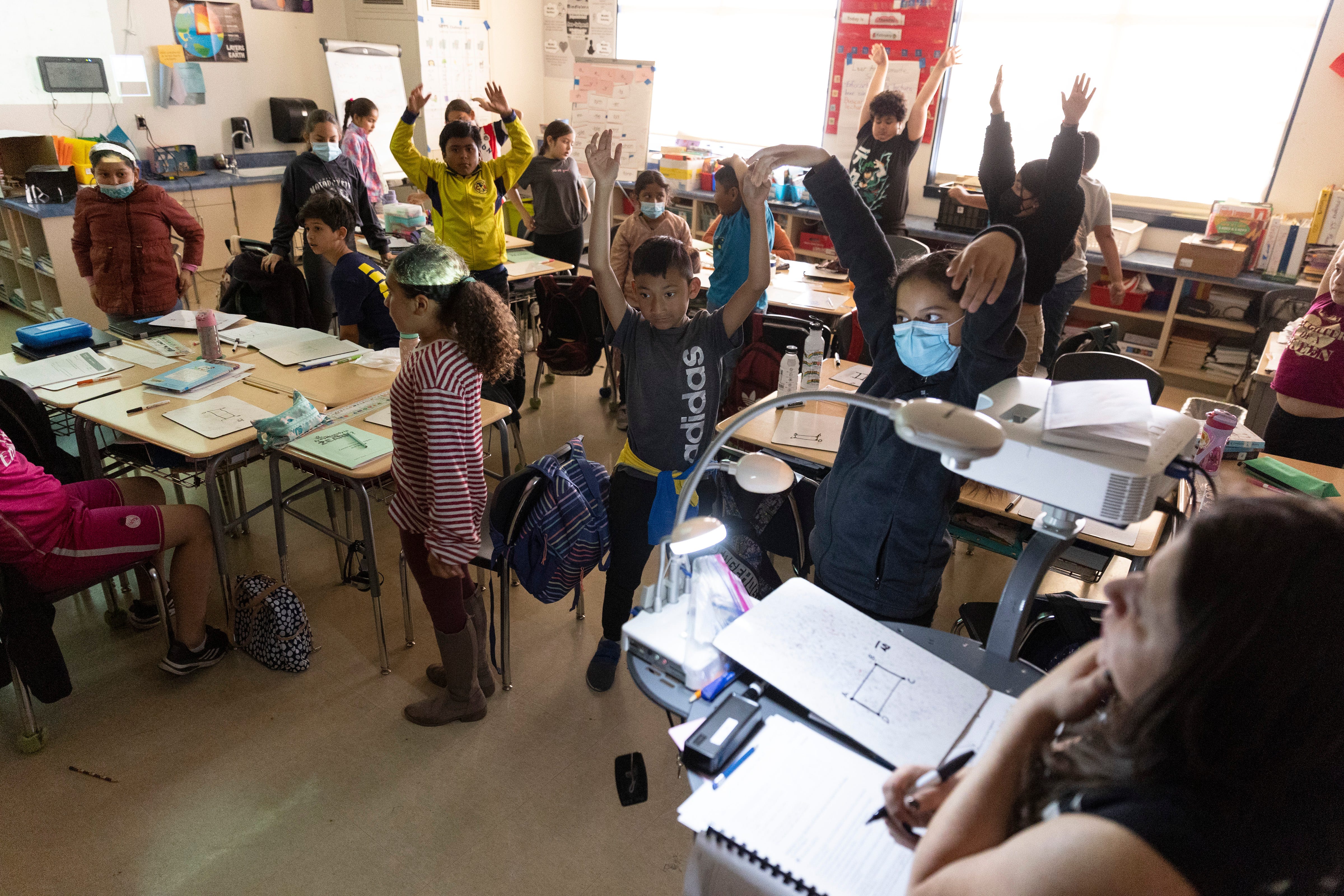 Wendy Gonzalez has her fourth grade class stand up stretch multiple times when they begin to be too rowdy and unfocused during class at Downer Elementary on Monday April 17, 2023; San Pablo, Calif.