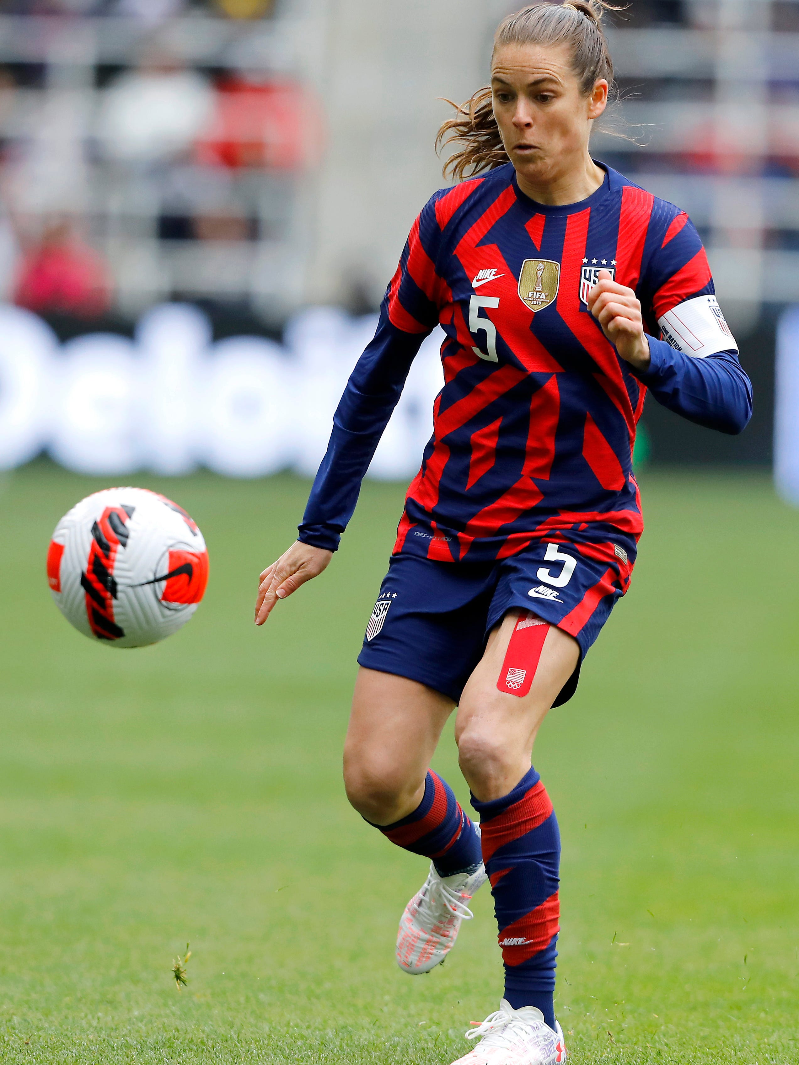 An action image of Kelley O'Hara playing soccer.