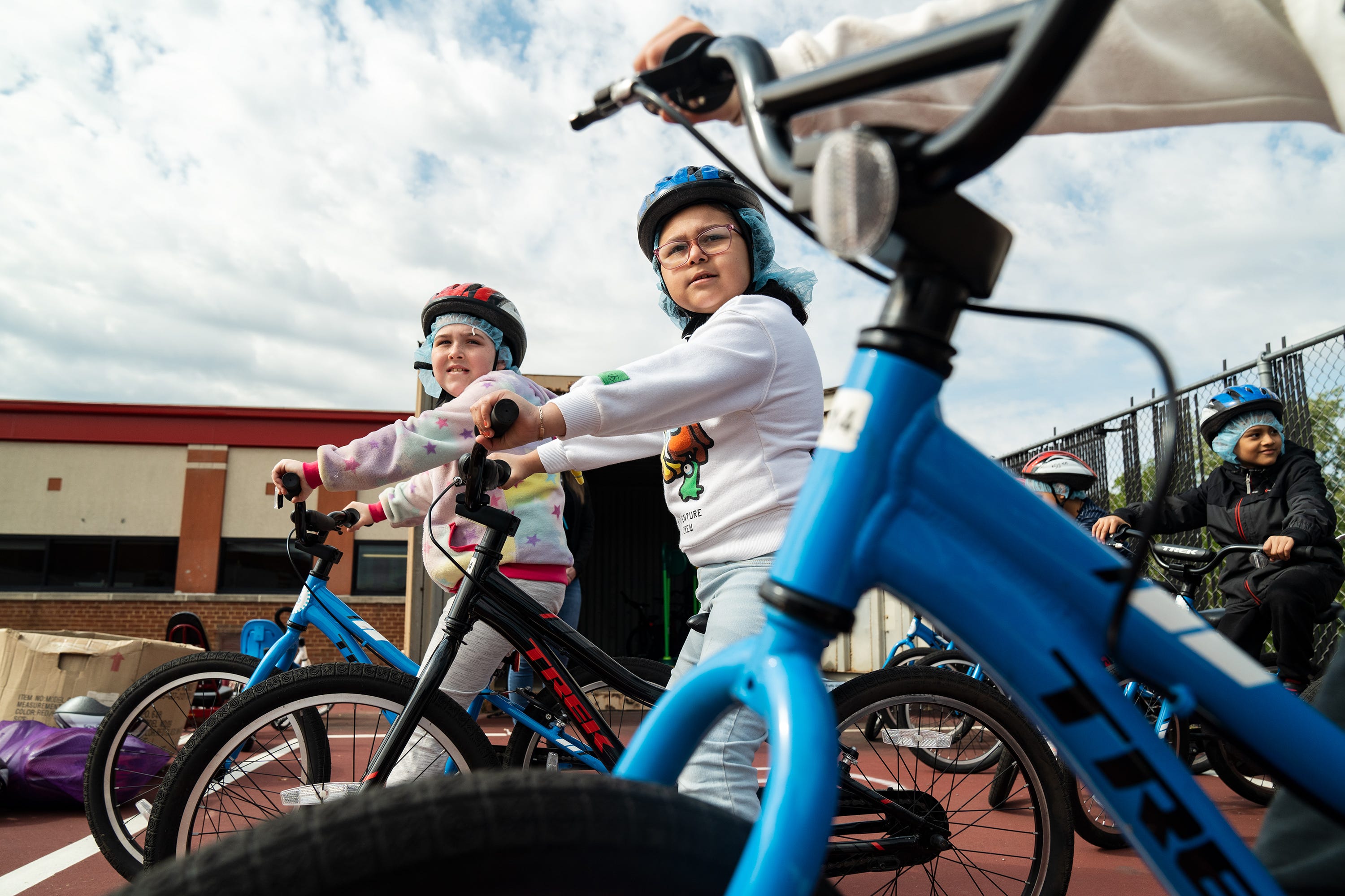 Ashley Soto, a third grader at Cora Kelly School in Alexandria, Va., listens to instructions with her classmates as they learn how to ride bikes during physical education