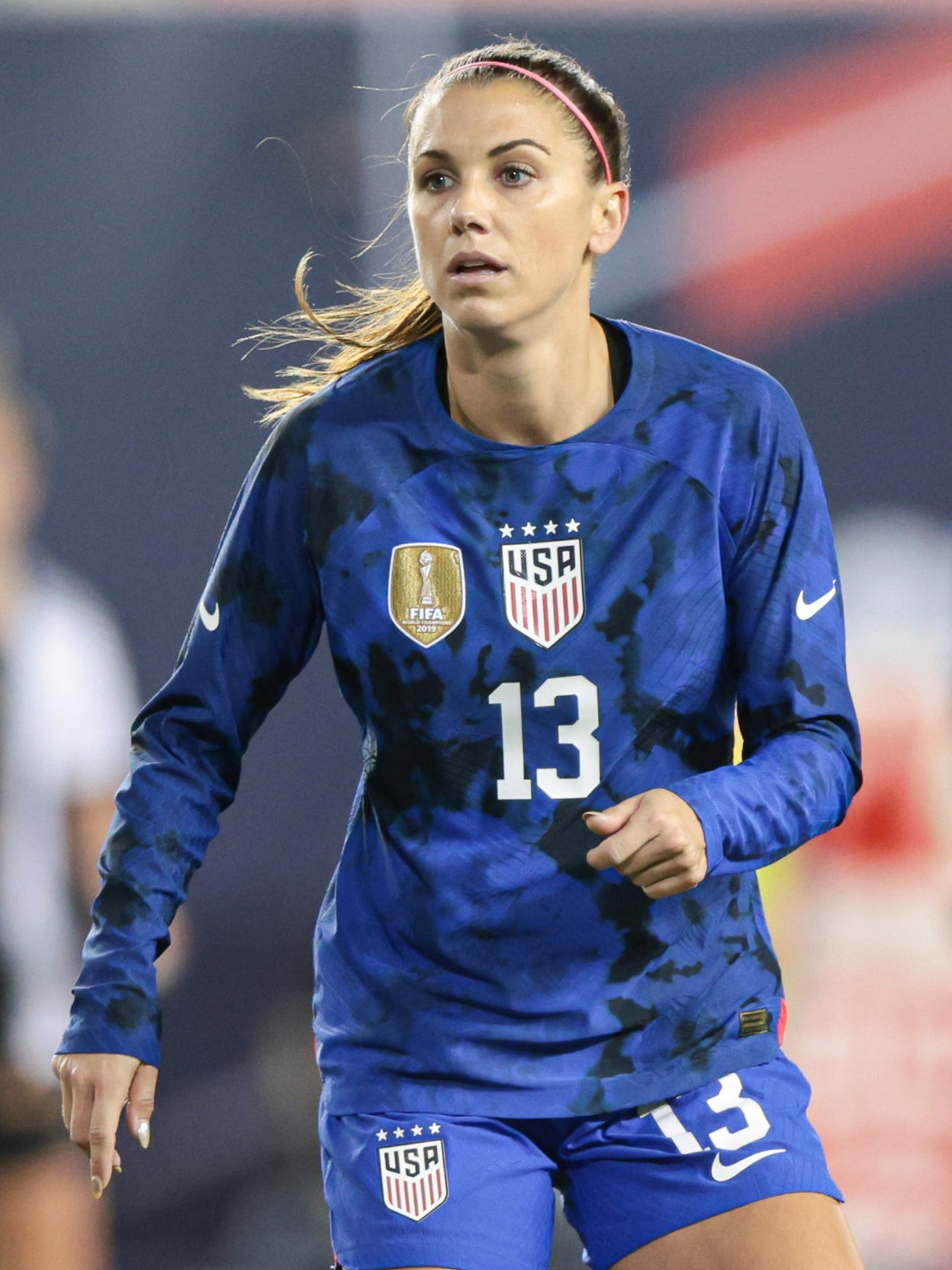 An action image of Alex Morgan playing soccer.