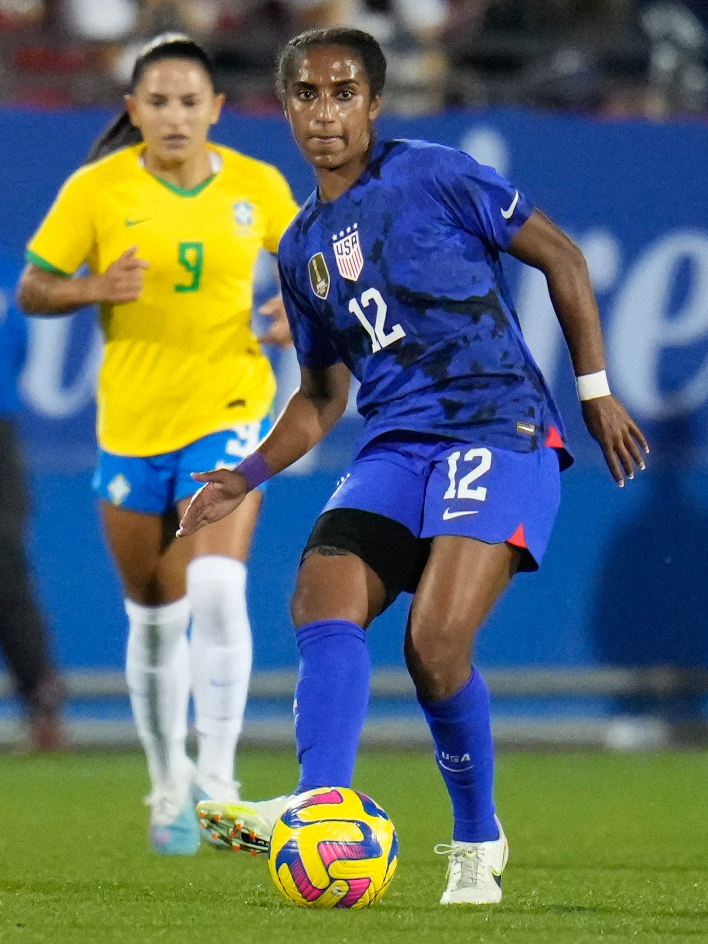 An action image of Naomi Girma playing soccer.