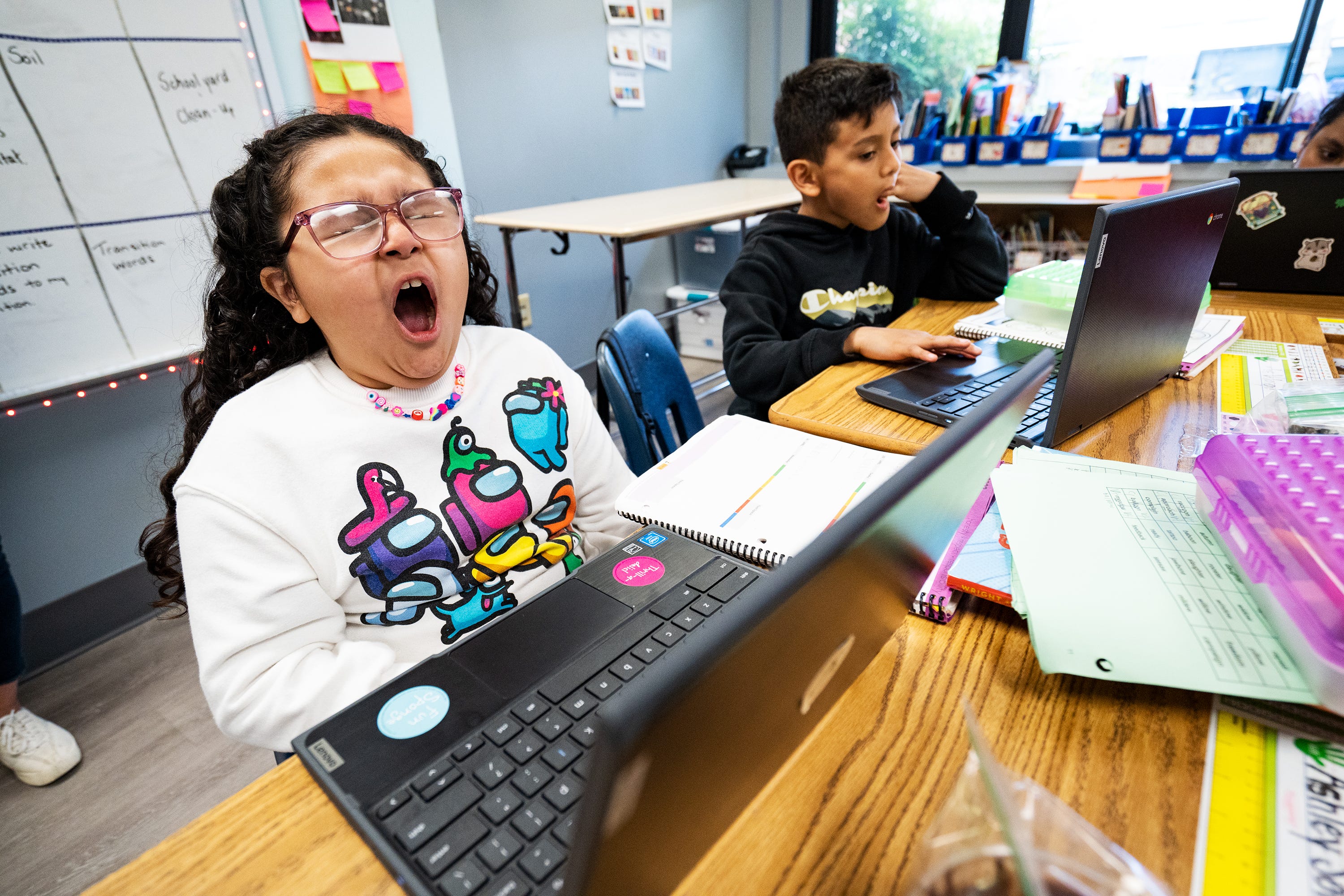 Ashley Soto, a third grader at Cora Kelly School, yawns as she attempts to finish her classwork near the end of the day.