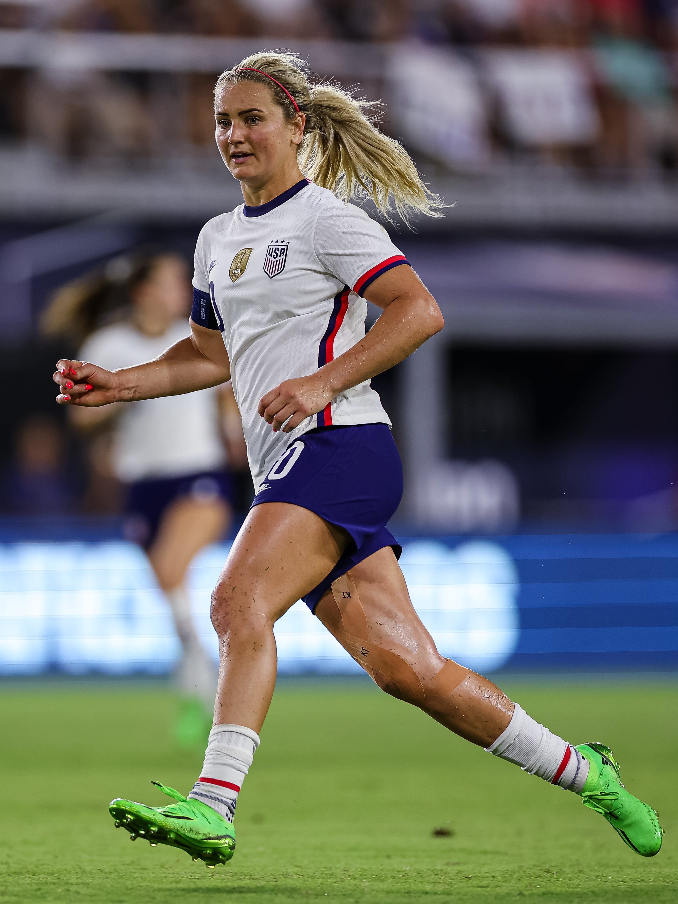 An action image of Lindsey Horan playing soccer.