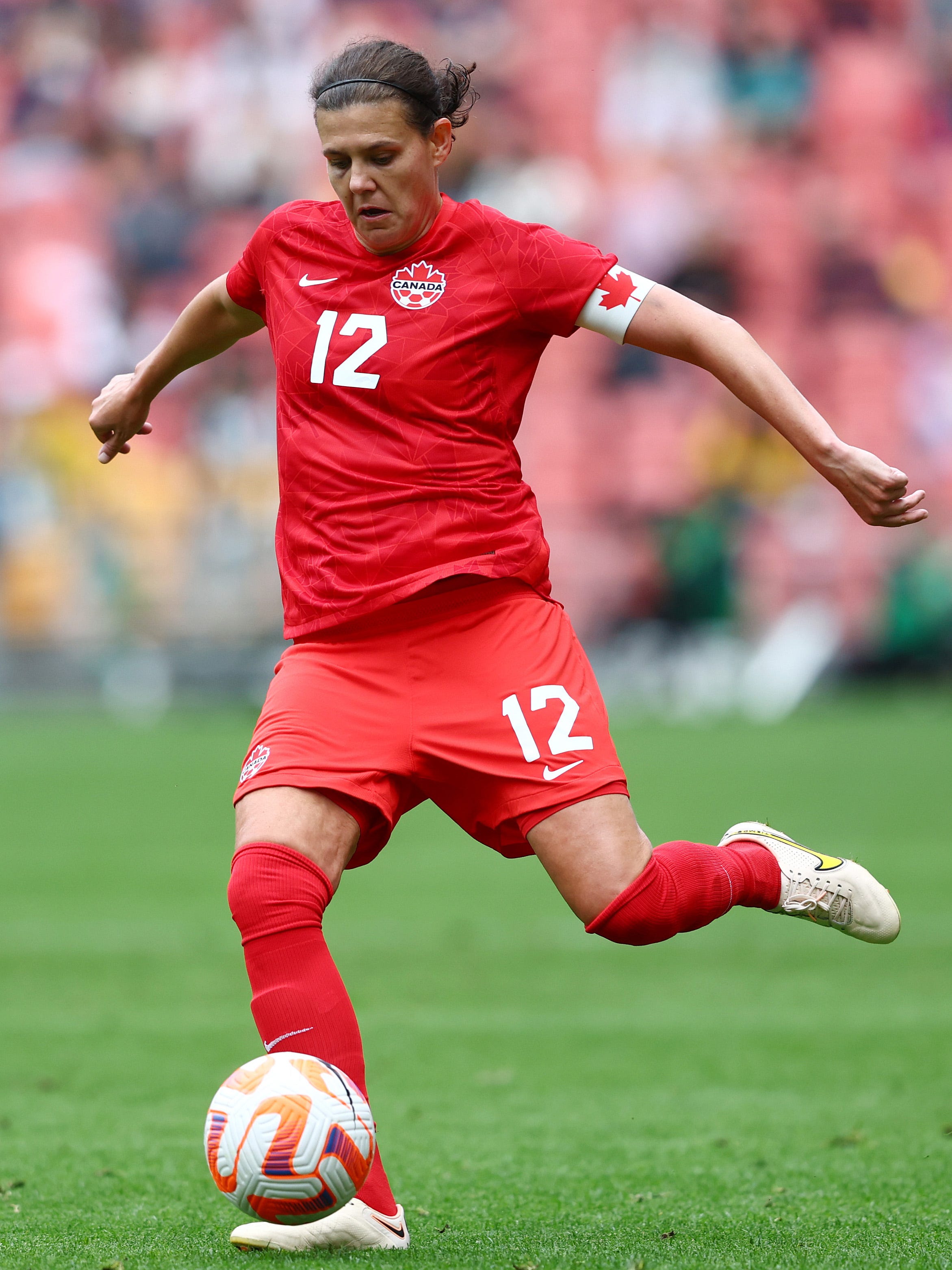 An action image of Christine Sinclair playing soccer.