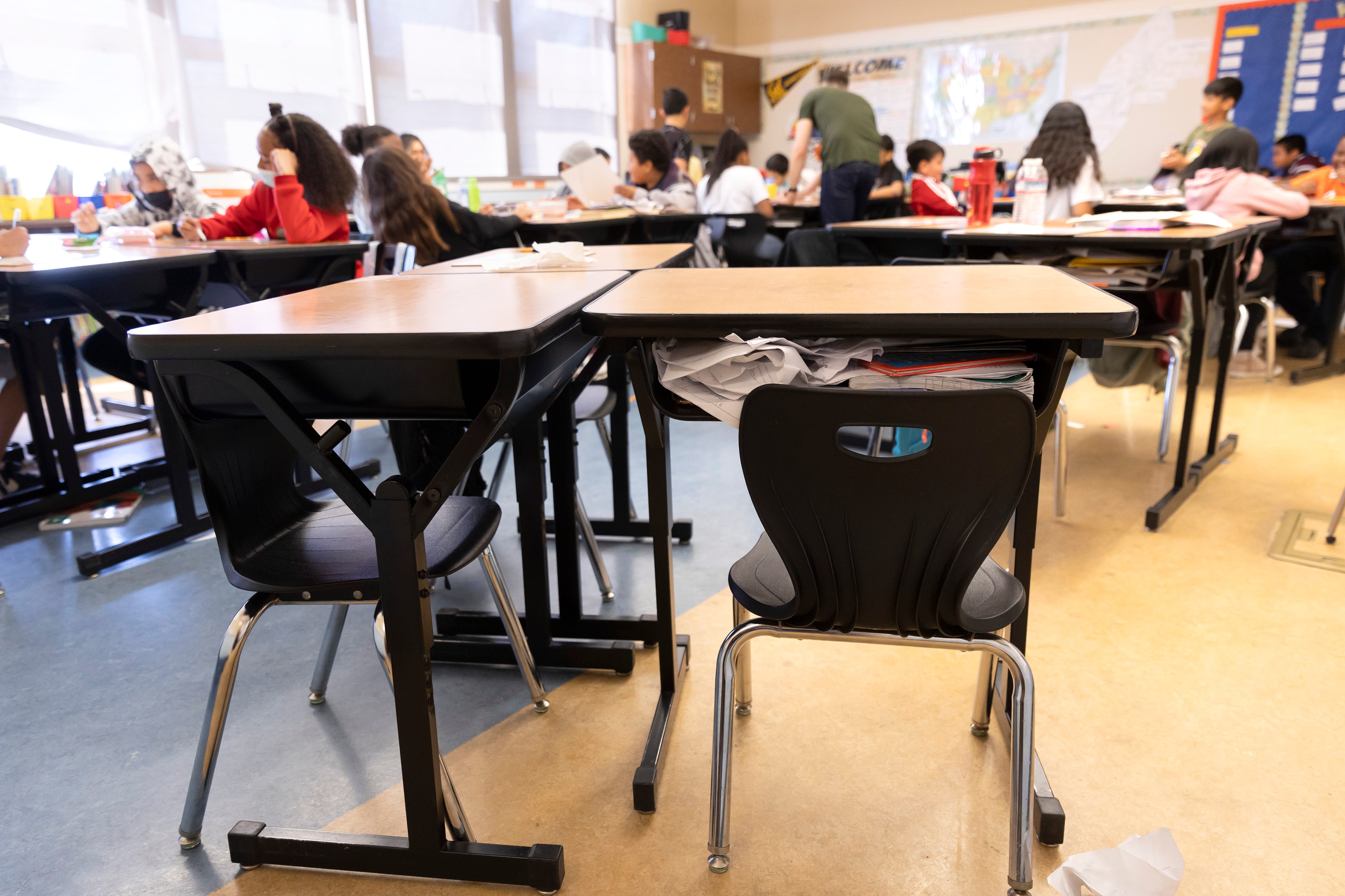 Crumpled papers are crammed into an empty desk belonging to Jayceon Davis, a student at Nystrom Elementary in Richmond, Calif.