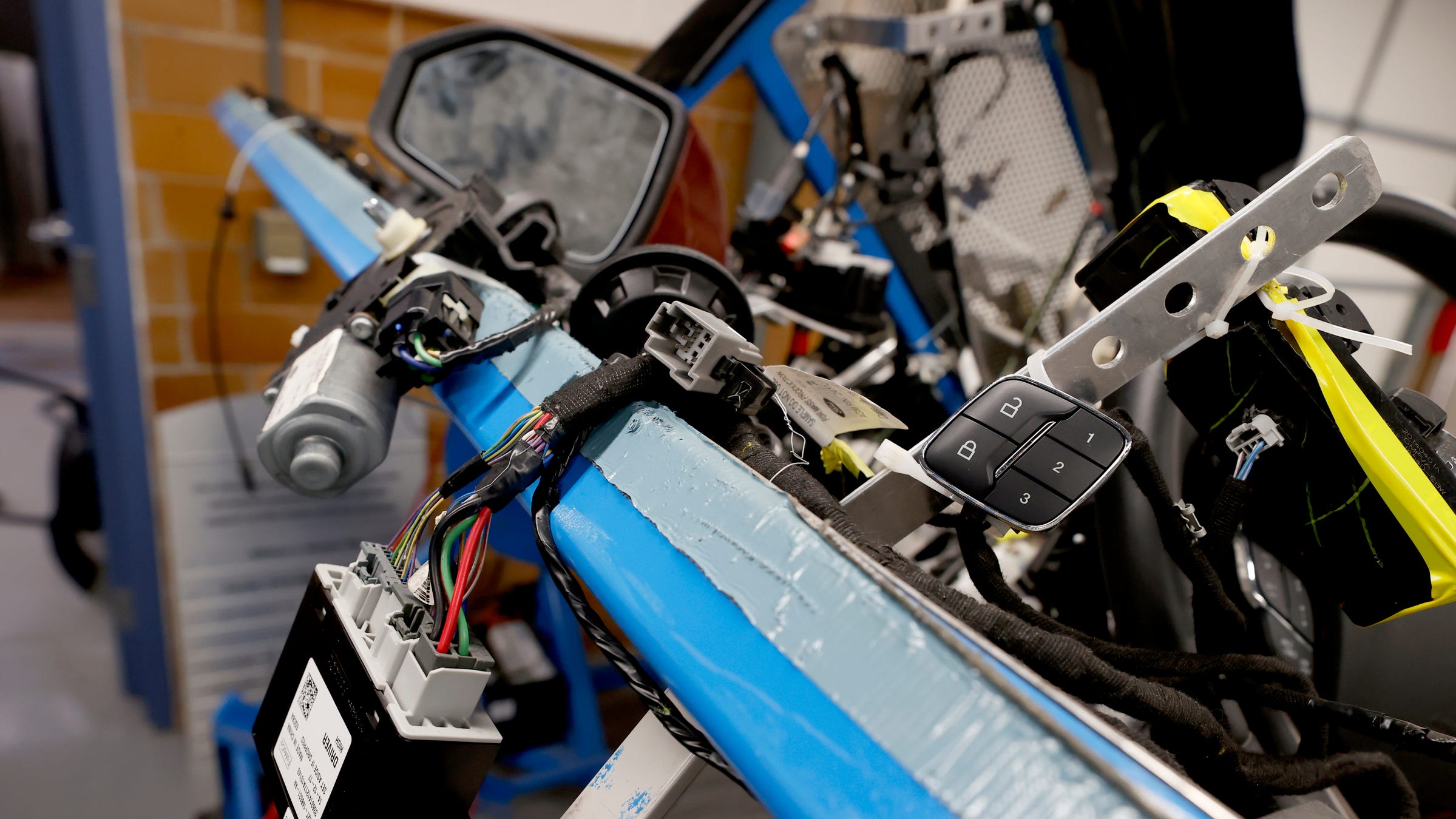 A Lincoln car with exposed wires and many modules inside the engineering lab on the campus of the University of Detroit Mercy in Detroit on Feb. 8, 2023.  The university has a new cyber engineering program and lab and with cars having more of these computer modules on board and the potential for being open to hacking the new lab is where students get real-world experience as well as learning and applying what they learn virtually.