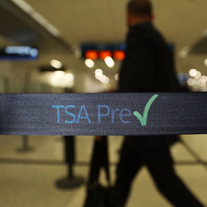 Travelers go through the TSA PreCheck security point at Miami International Airport in this file photo.